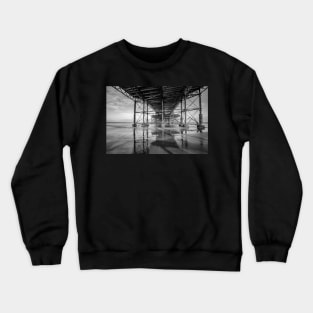 Underneath the wooden boardwalk of a Victorian pier on the Norfolk coast Crewneck Sweatshirt